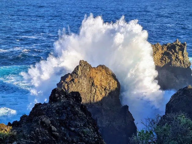 Powerful ocean waves crashing against rocks